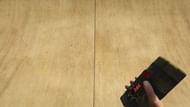 A player holding a Sticky Bomb in 1st POV in GTA 5 (Image via Rockstar Games)